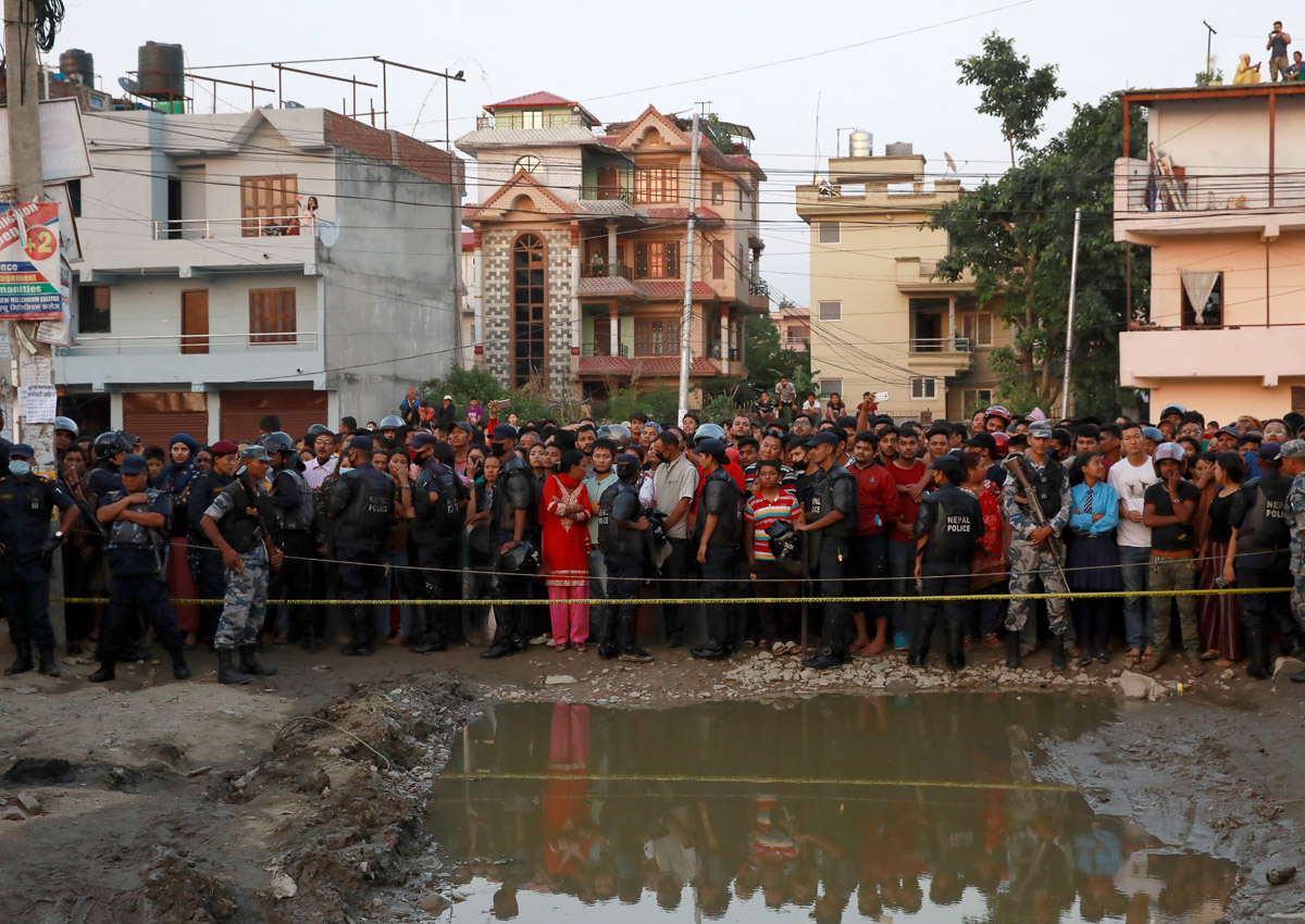 People gather near an explosion site in Kathmandu, Nepal May 26, 2019.