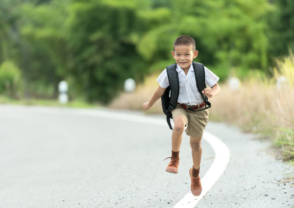 kid running with backpack