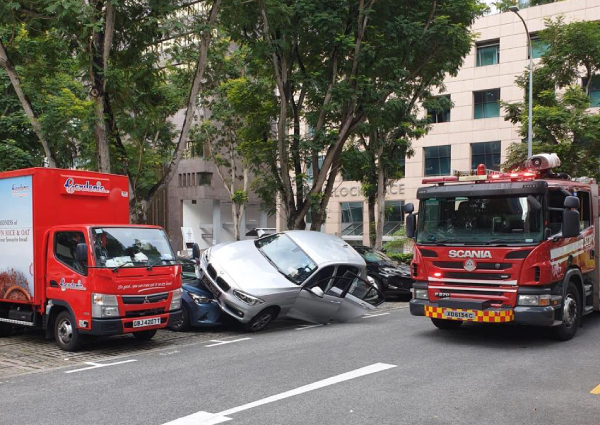 BMW Driven By Elderly Woman Crashes Into And Mounts Cars At 