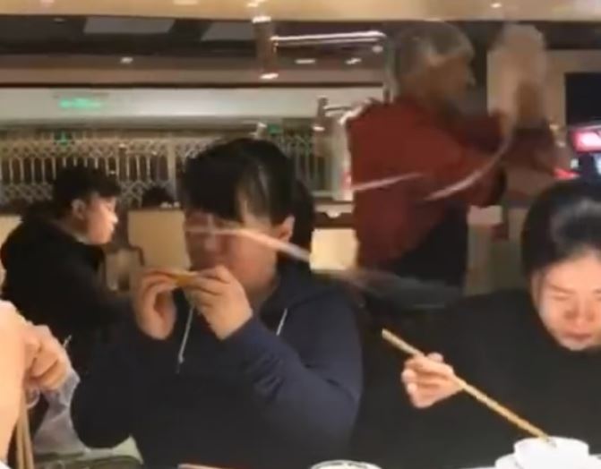 Woman gets slapped in the eyes by 'flying noodle' at hotpot restaurant ...