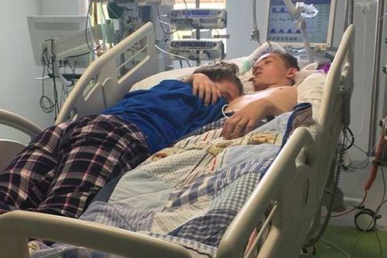 Photo of girl giving boyfriend last hug before his life support is