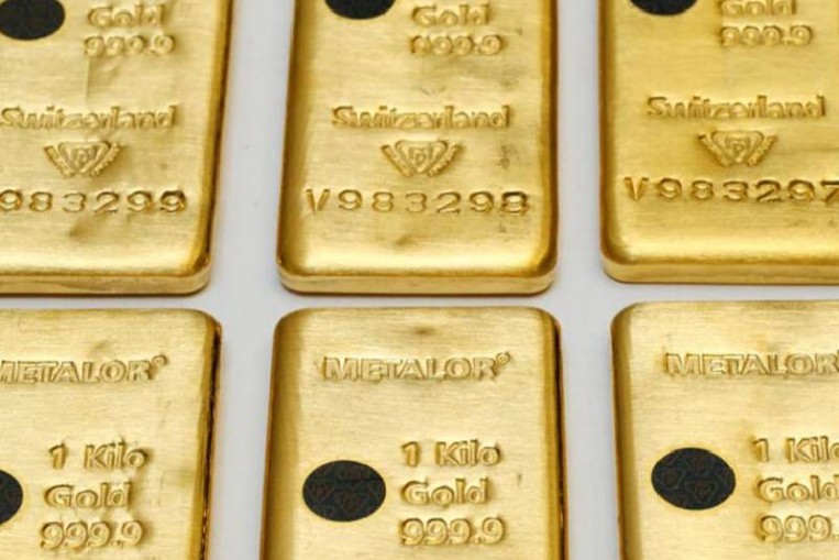 Gold hits over 1-week high as dollar dips, World News - AsiaOne