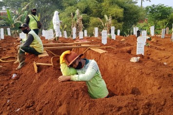 Burying his anguish: Indonesian gravedigger lays to rest dozens of Covid-19 victims each day